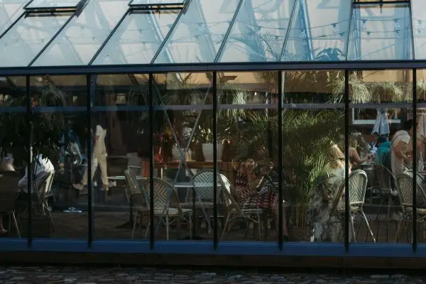 a group of people sitting at a table outside of a building